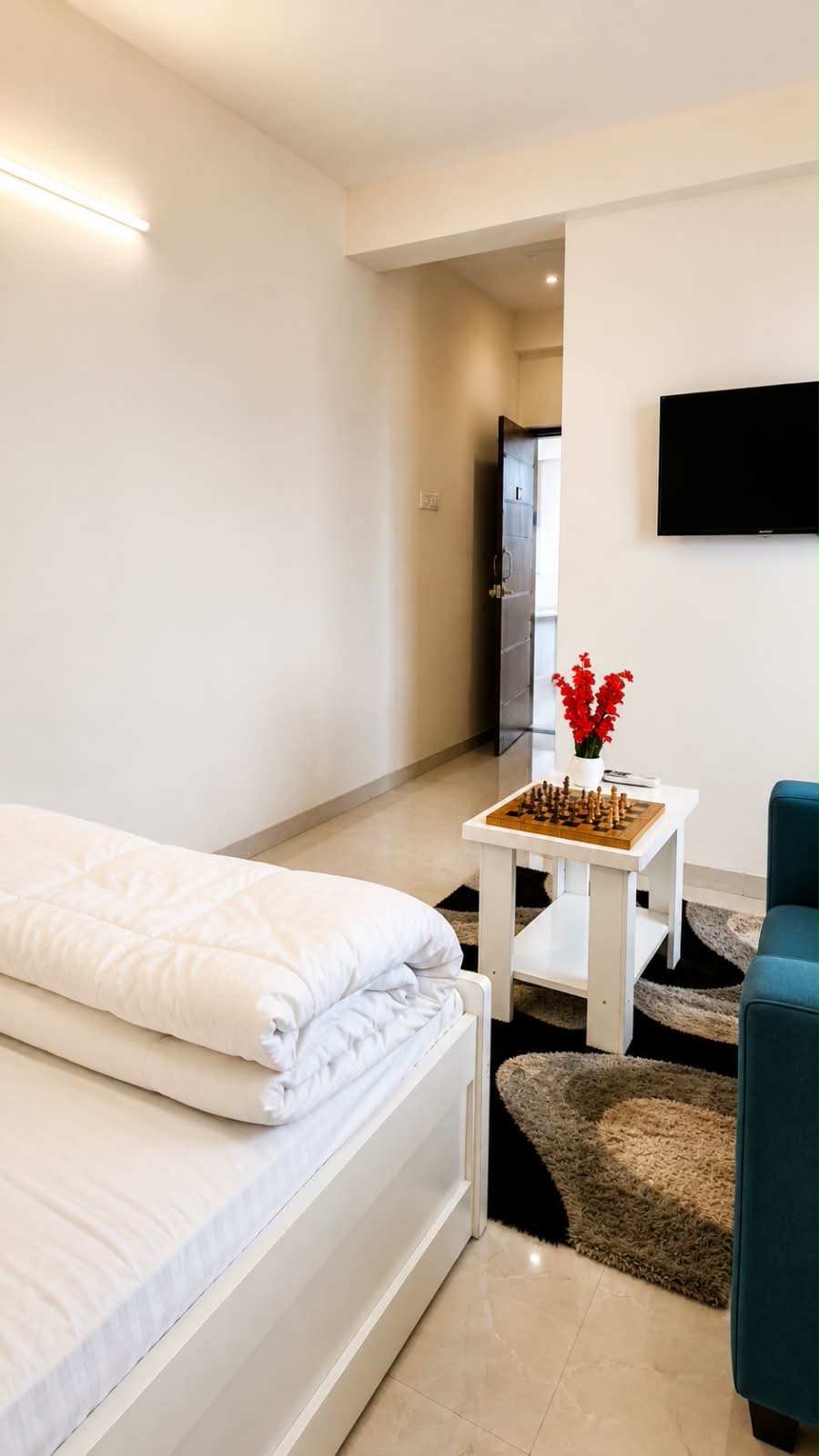 Private room with bed, television, armchair and chess table